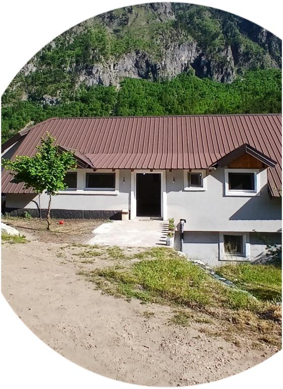 a white house with a red roof at Bujtina Sherifaj in Valbonë