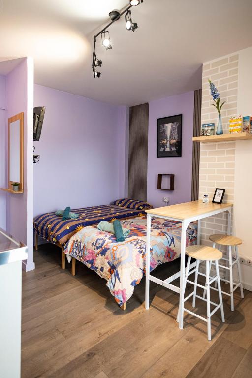une chambre avec un lit, un bureau et une table dans l'établissement Cozy compact studio France, à Saint-Louis