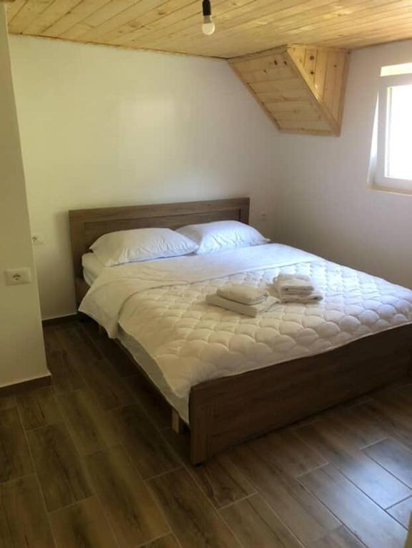 a bedroom with a bed with two towels on it at Bujtina Sherifaj in Valbonë