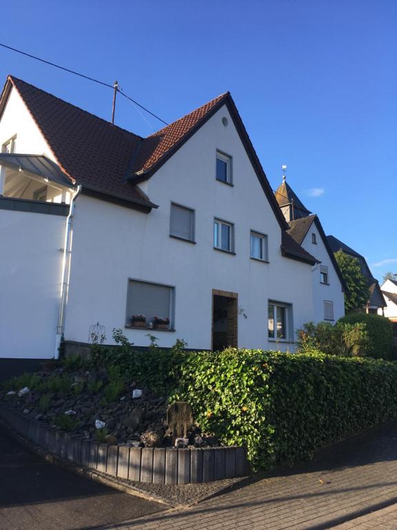 a white house with a black roof at Gästezimmer Waldblick am Nürburgring in Wimbach