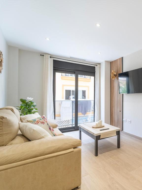 a living room with a couch and a table at Gala Holidays City Center and Beach in Fuengirola