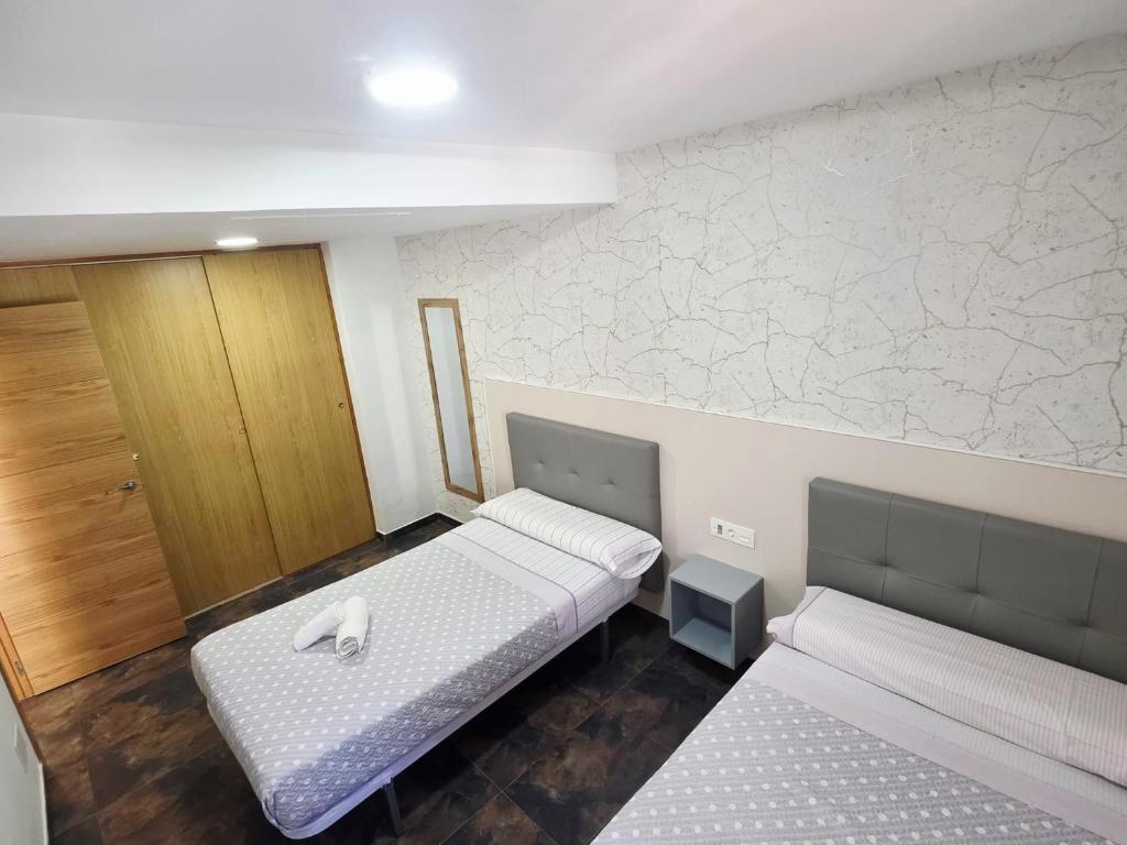 A bed or beds in a room at Apartamento calle de la Cordera, 3