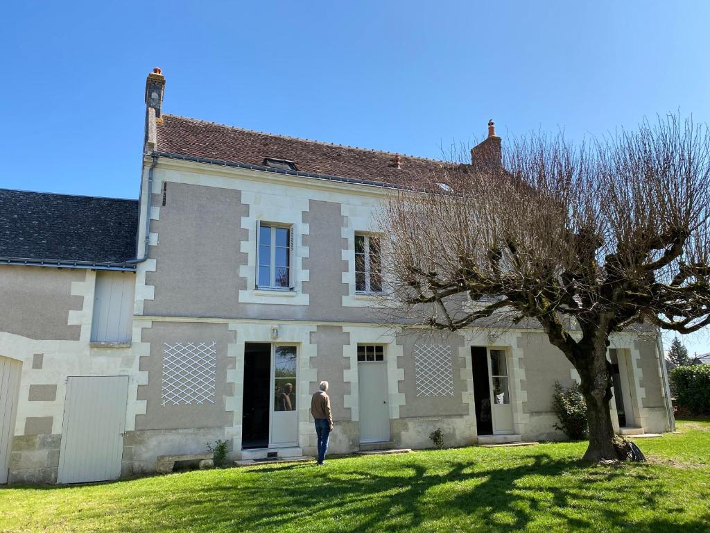 a man standing in front of a house at La maison de Théophile in Sepmes