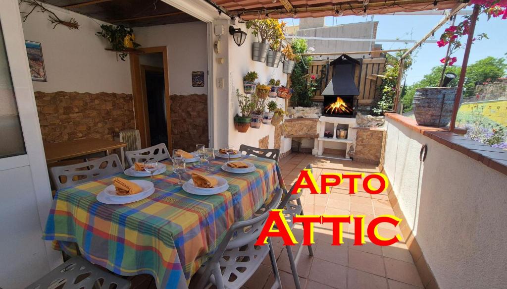 a table with plates of food on it on a patio at Ático, terraza y Barbacoa in Barcelona