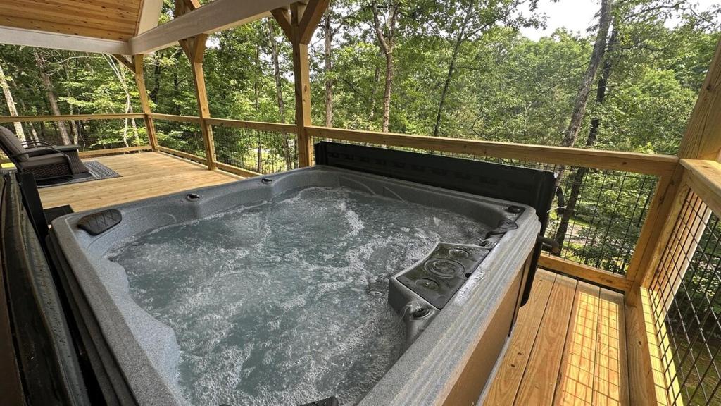 a hot tub on the deck of a tree house at Ultimate Couples Retreat w Fenced Yard for Pet in Cleveland