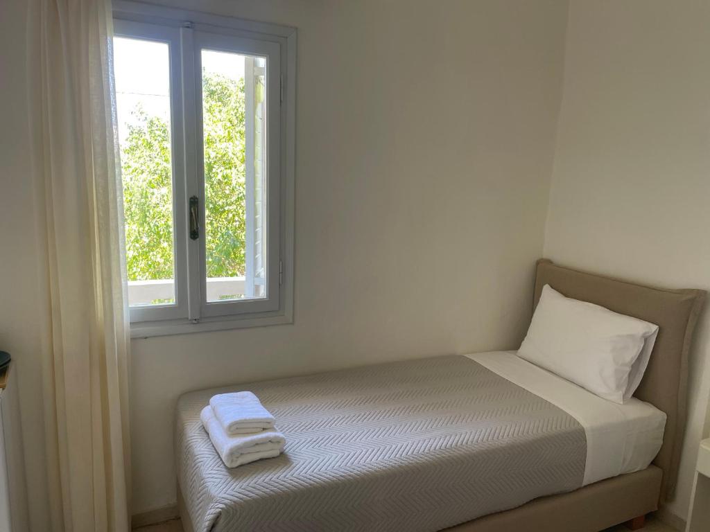 a bed sitting in a room with a window at Villa Sylvia in Matala