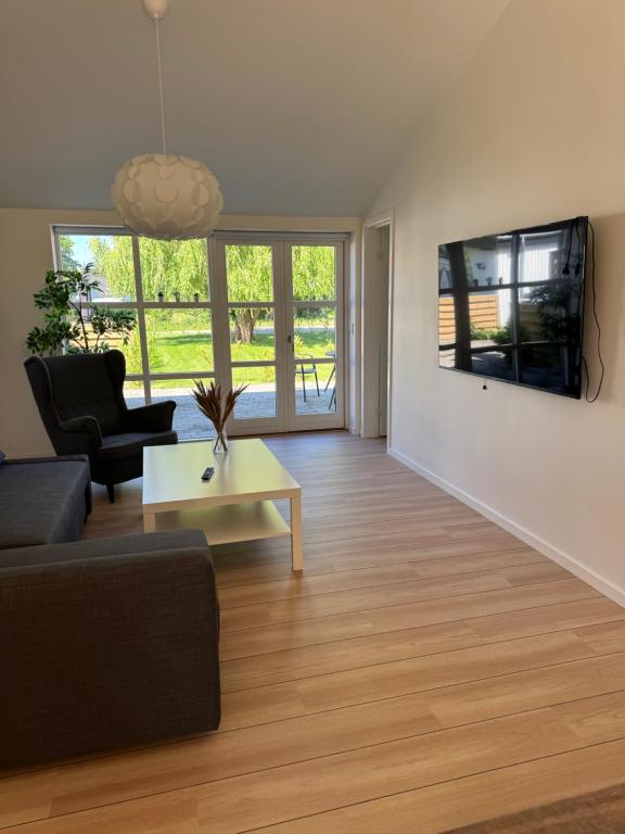 a living room with a couch and a table at Bøtø strand ferielejlighed 4 in Bøtø By