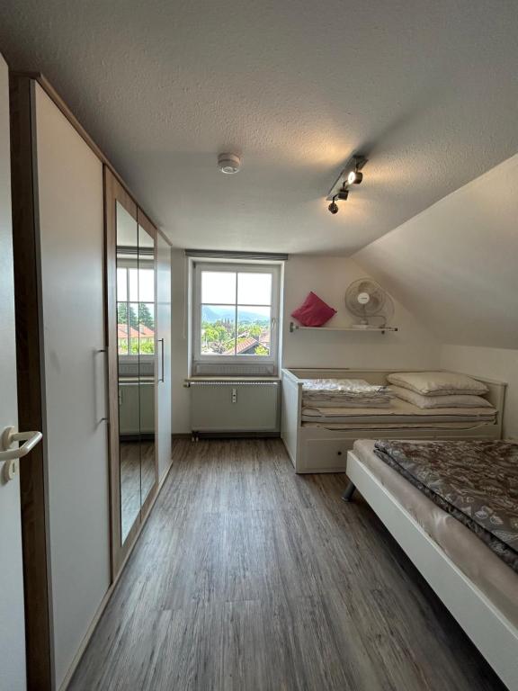 a small room with a bed and a window at Herzensnest mit Grüntenblick in Immenstadt in Immenstadt im Allgäu