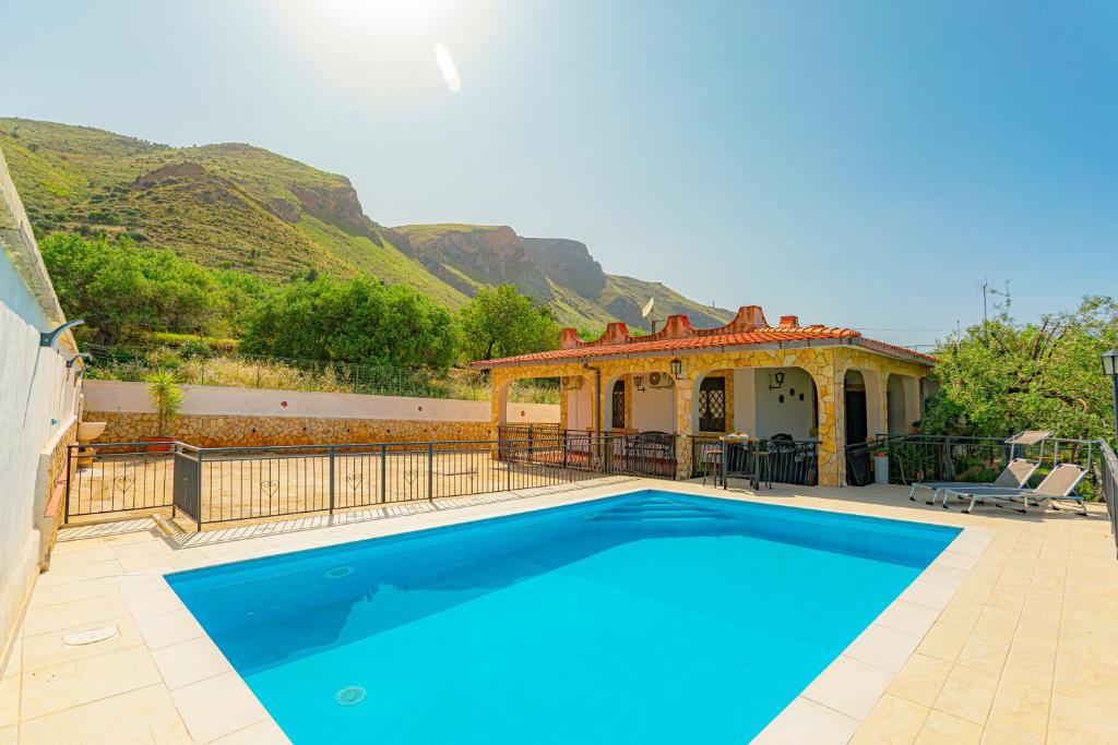 a villa with a swimming pool and a house at villa ulivo rovetto in Mandra Capreria