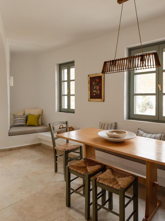 a dining room with a table and chairs and a couch at VERANNA Patmos D3 in Patmos