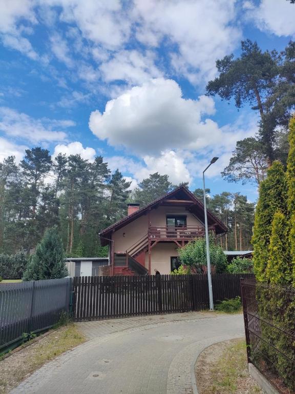 a house with a fence in front of it at Apartament GRZEŚ in Wielen Zaobrzanski