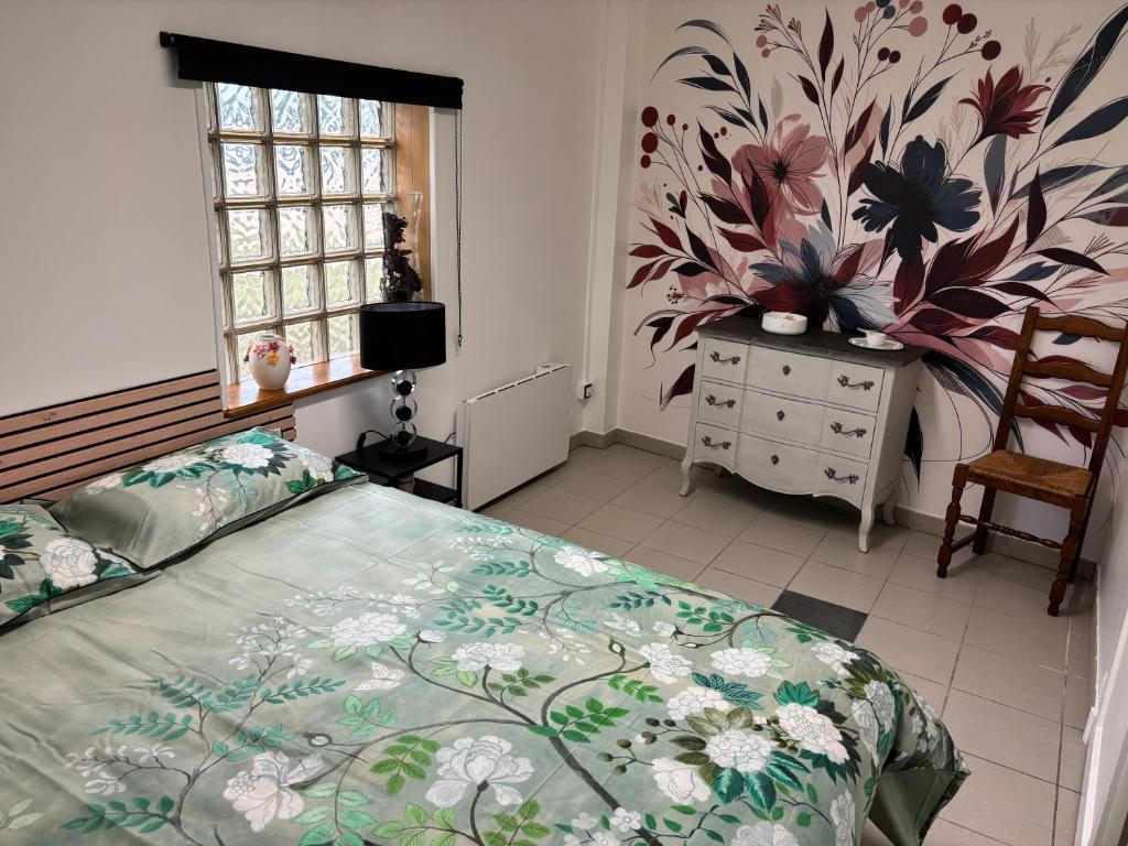 a bedroom with a bed and a dresser and a window at Le bureau in Digoin