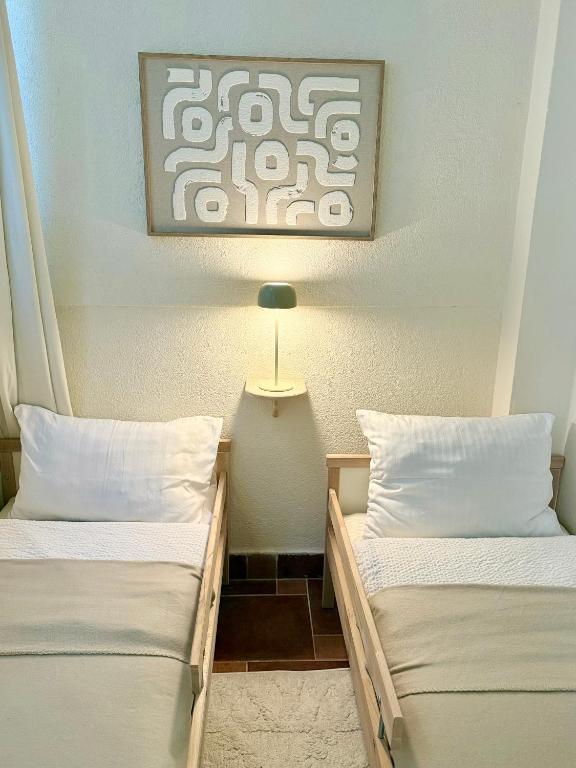 two beds sitting next to each other in a room at Hotel Villa Perla Di Mare in Budva