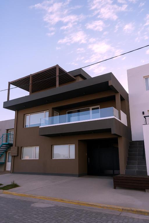 a large building with a lot of windows at La ola in Puerto Pirámides
