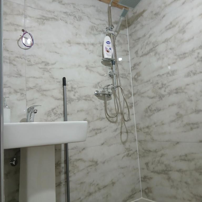 a bathroom with a shower and a sink at Bujtina Sherifaj in Valbonë