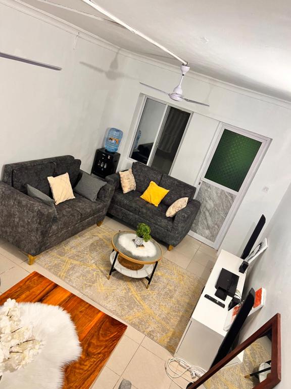 a living room with a couch and a table at AnnexSarova Homestay in Migombani