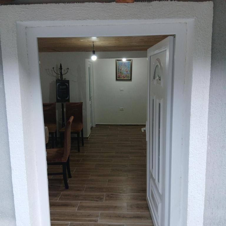 a hallway with a door leading to a dining room at Bujtina Sherifaj in Valbonë