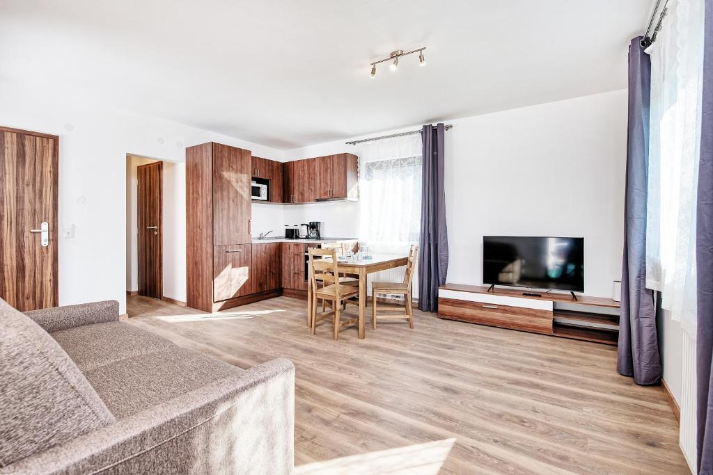 a living room with a couch and a dining room at Haus unter Gerlitzen in Bodensdorf