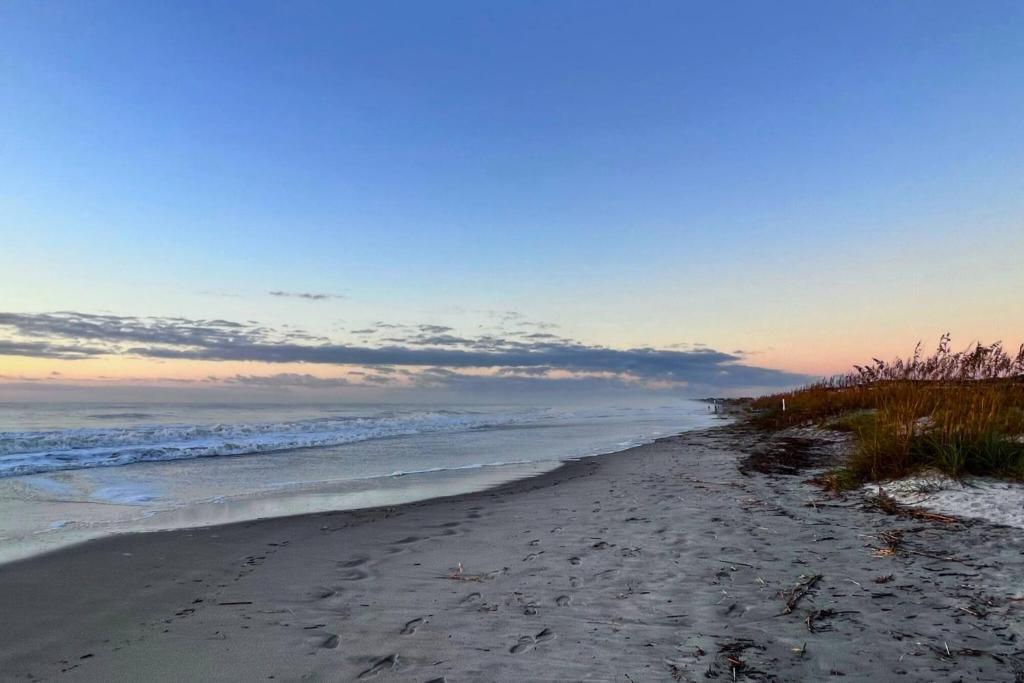 a sandy beach with the ocean in the background at Salty Air & Sea Breezes in Hilton Head Island
