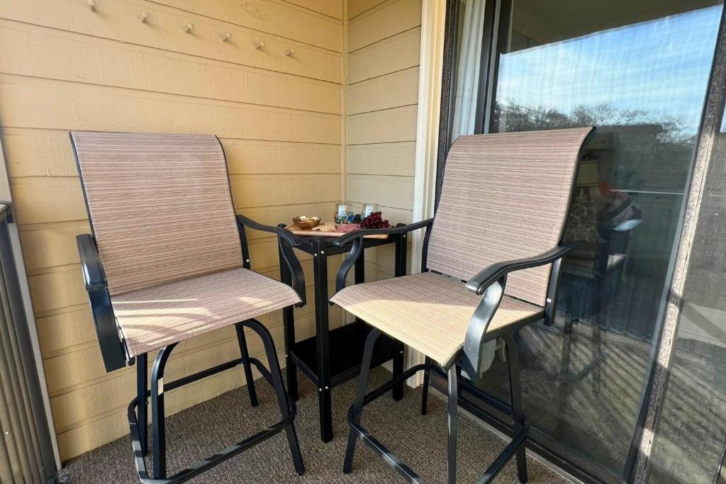 two chairs and a table on a porch at Salty Air & Sea Breezes in Hilton Head Island