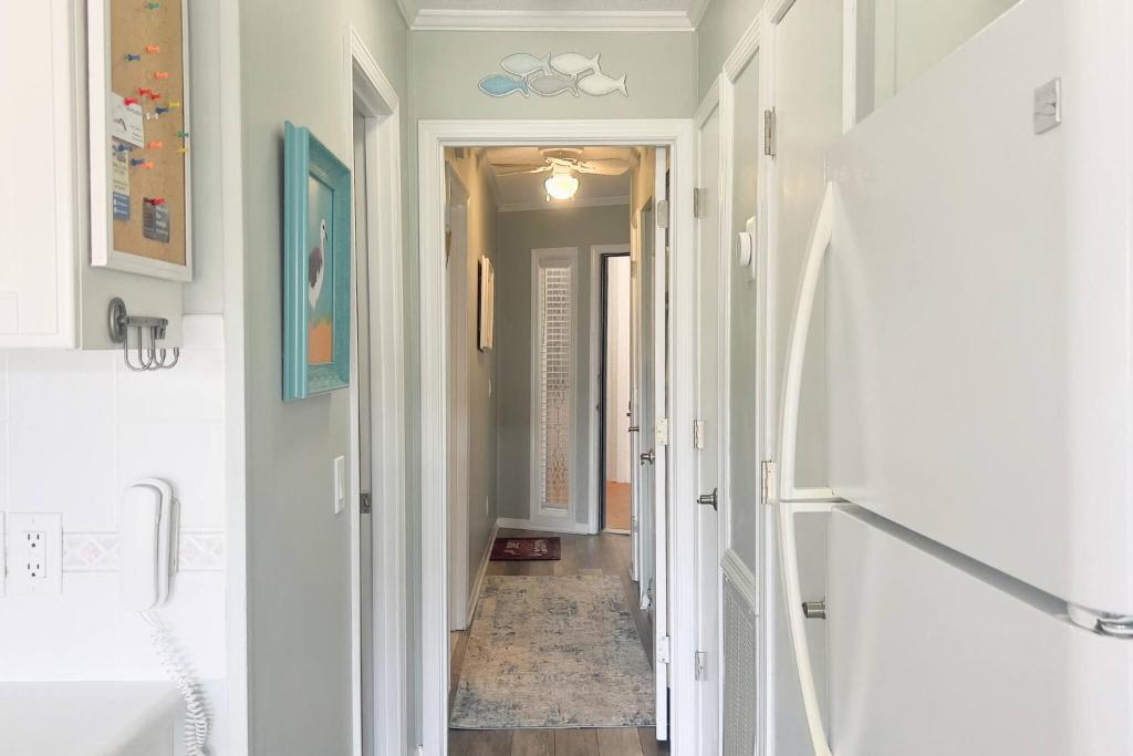 a hallway with a hallway leading into a room with a hallway at Salty Air & Sea Breezes in Hilton Head Island