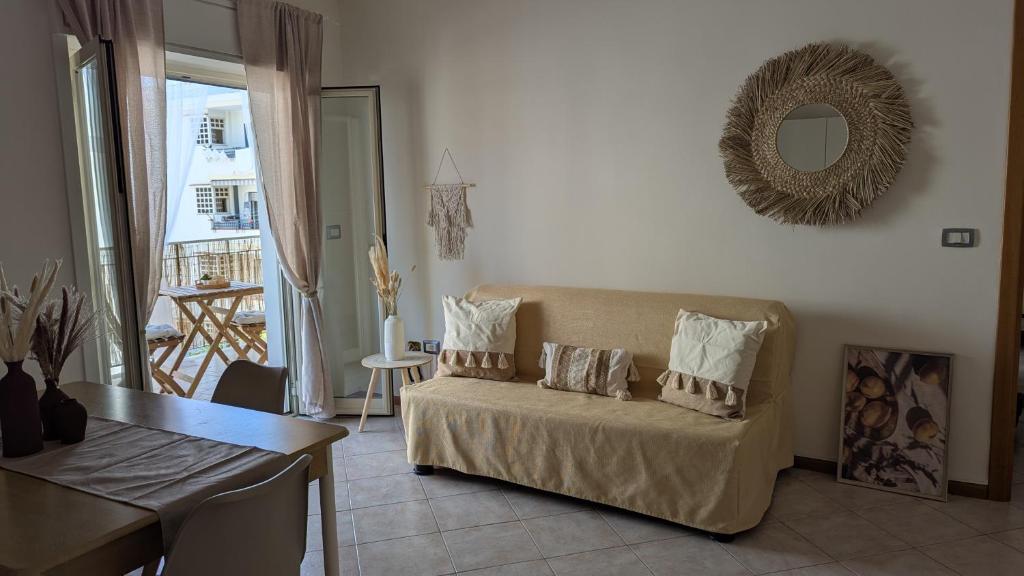 a living room with a couch and a table at Ficu e Sali in Roccalumera
