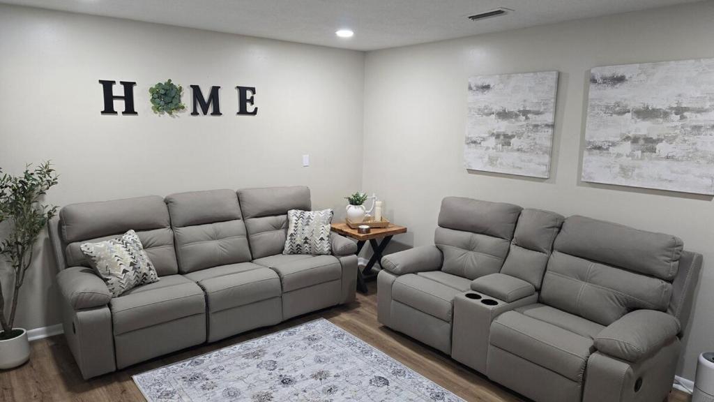 a living room with two couches and a table at The Miller's Retreat in Dothan