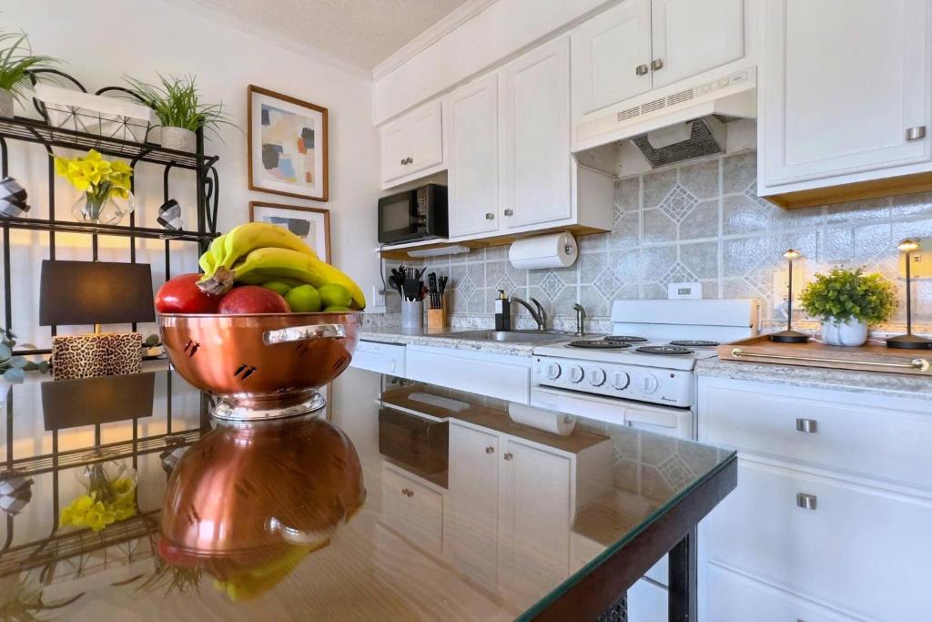 a kitchen with a bowl of fruit on a counter at Dunes with Design in Hilton Head Island