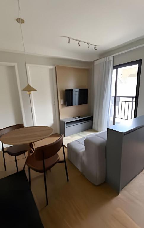 a hotel room with a bed and a desk and a table at Max Jardim São Paulo in São Paulo
