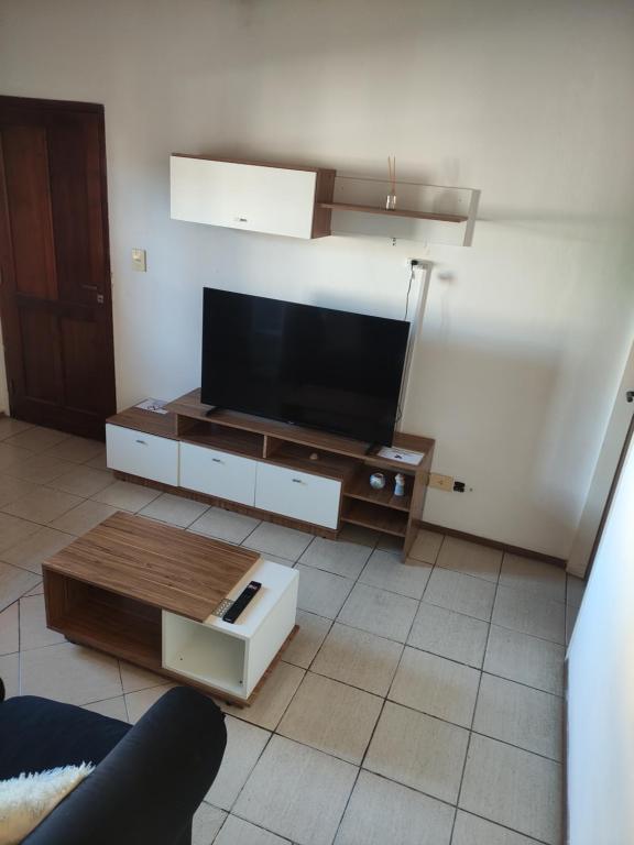 a living room with a flat screen tv on a table at Departamento céntrico en San Nicolas IG martindebra22 in San Nicolás de los Arroyos