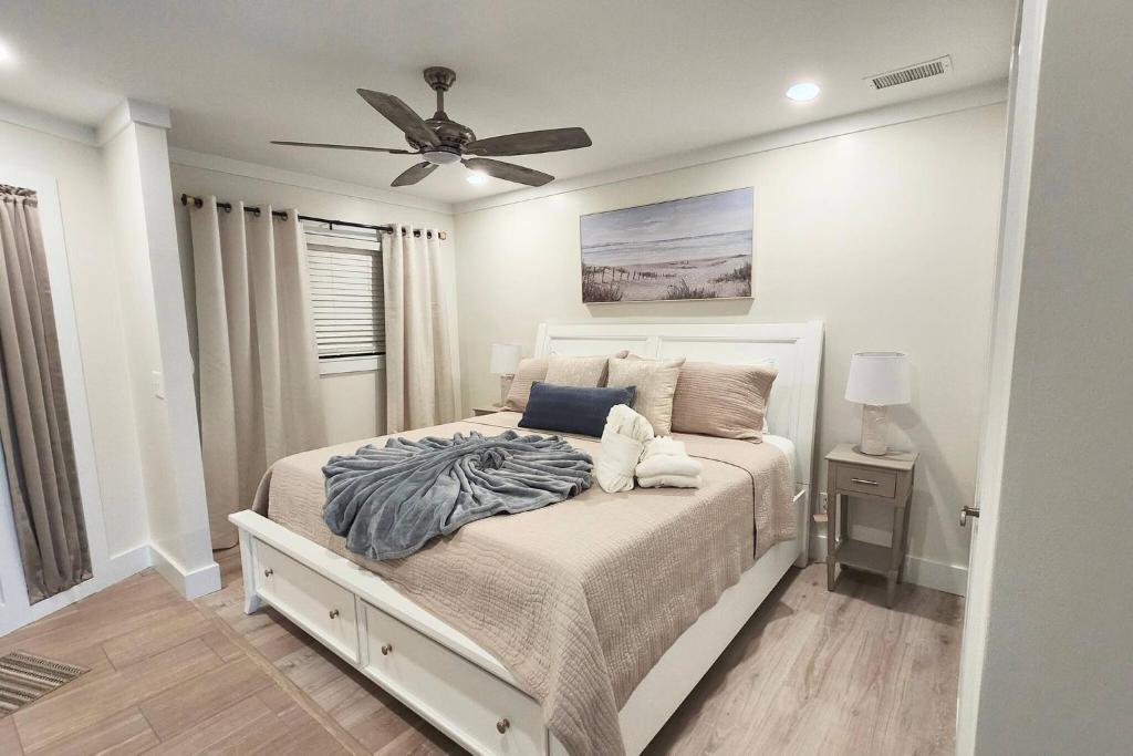 a bedroom with a bed with a ceiling fan at Southern Serenity, an HHI Beachfront Resort in Hilton Head Island