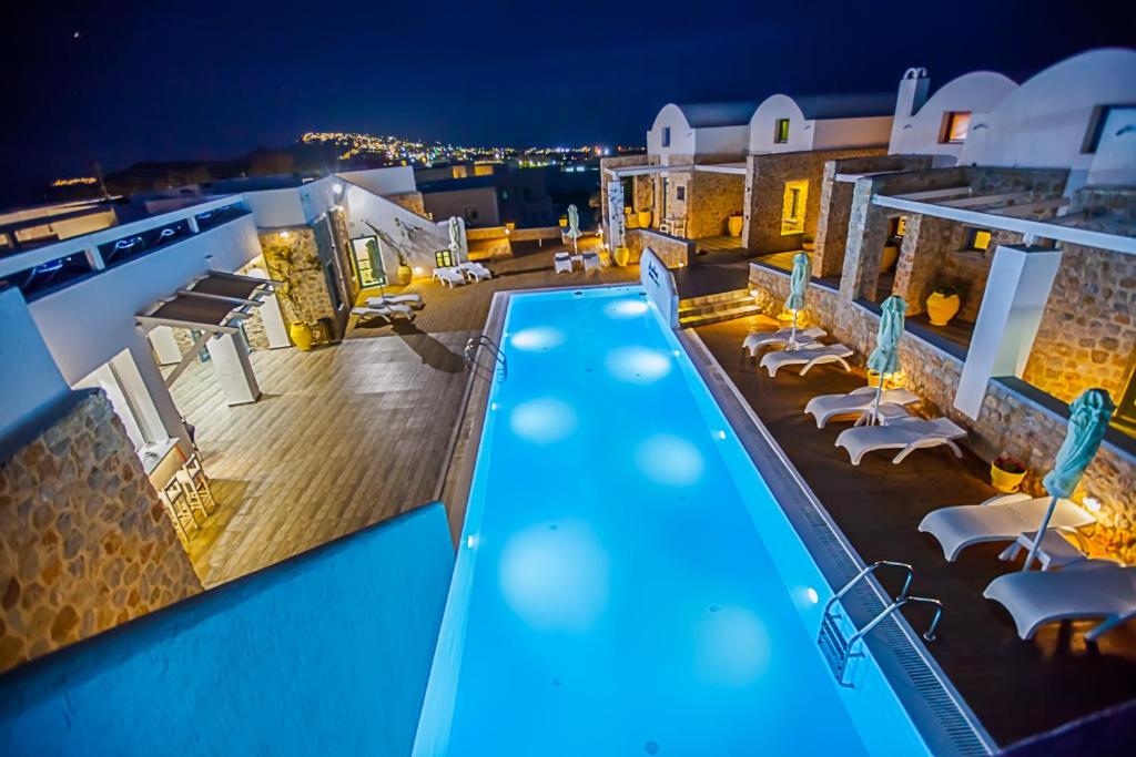 a view of a swimming pool at night at Nautilus Dome in Fira