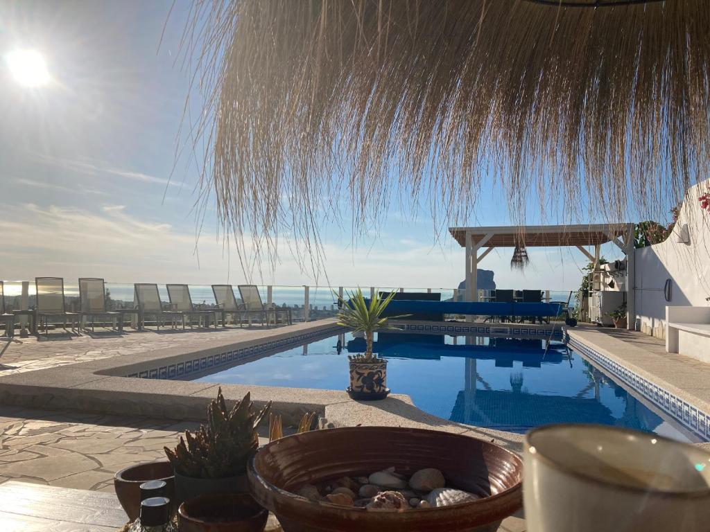 a swimming pool with a view of the ocean at Ons Spanje in Calpe