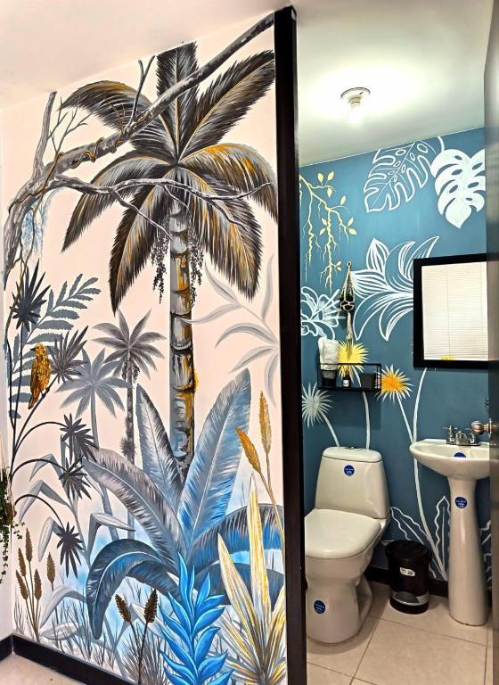 a bathroom with a palm tree mural on the wall at Gaia512A in Montenegro