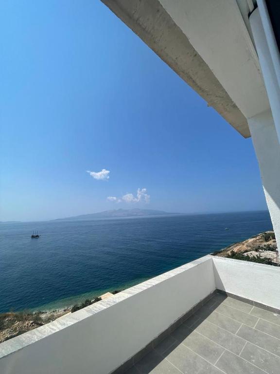 a view of the ocean from a balcony at Villa Besnik in Sarandë