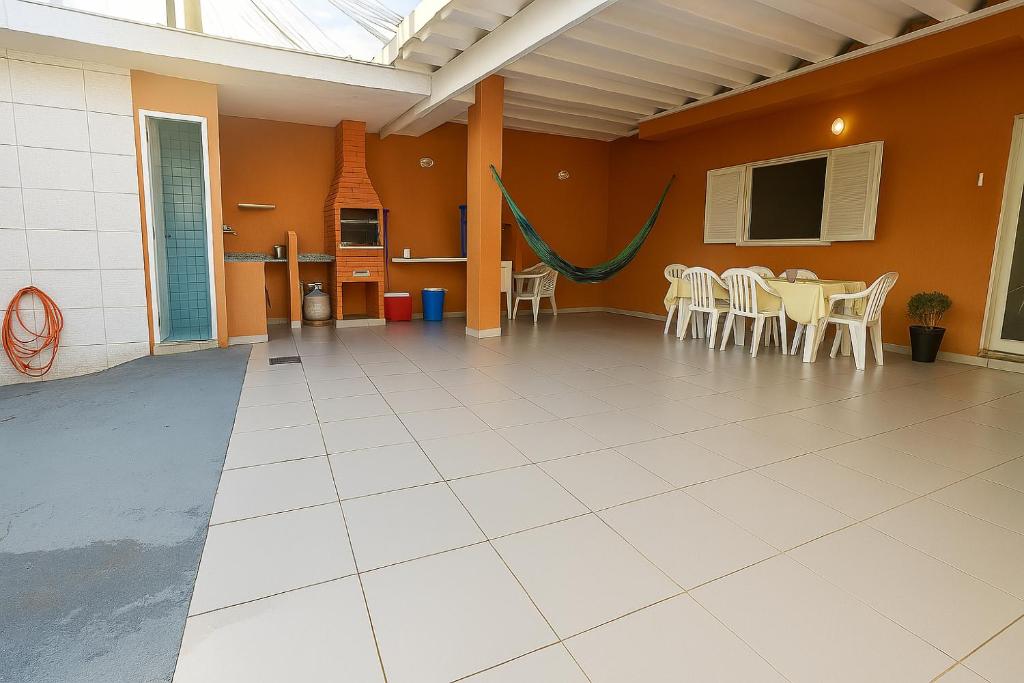 a large room with tables and chairs in it at casa do Pedro in Guarujá