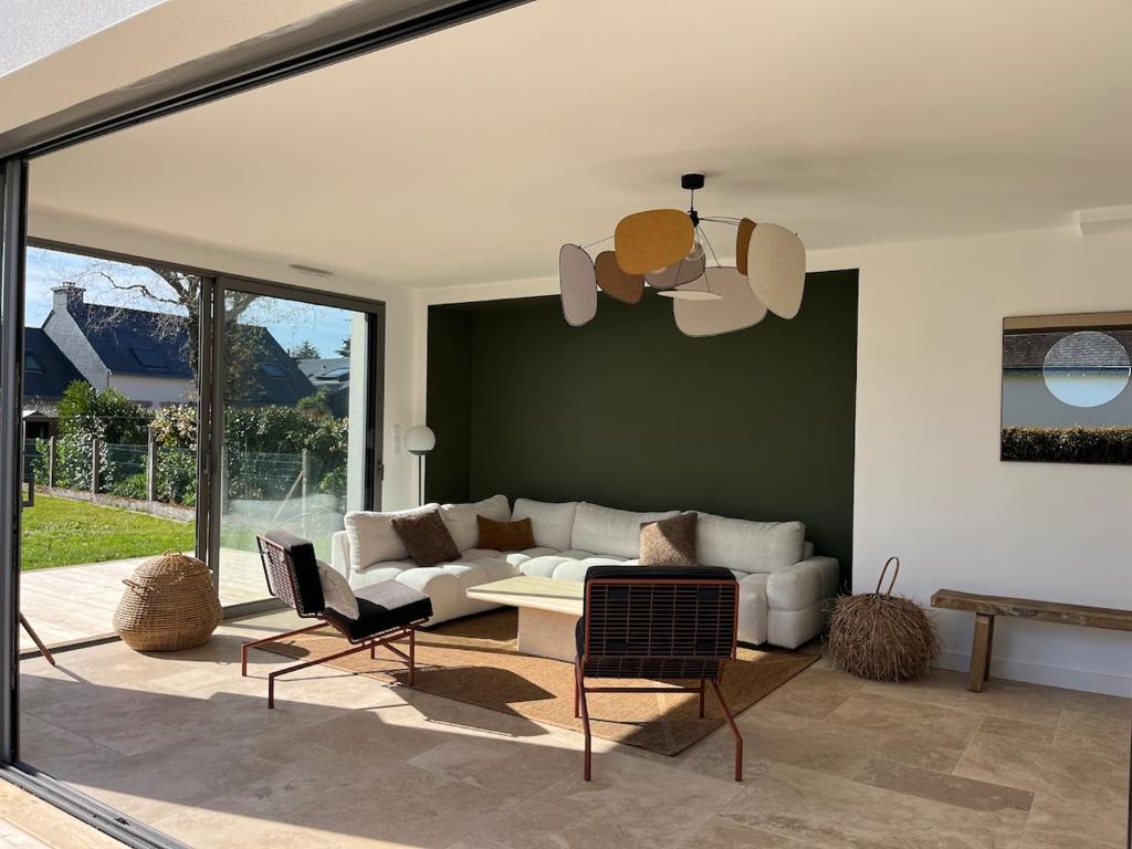un salon avec un canapé, une table et des chaises dans l'établissement Maison Guelan Kerners, à Arzon