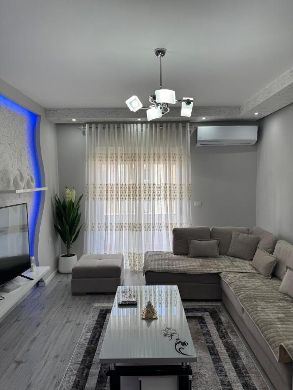 a living room with a couch and a table at Eriksens Apartment in Pogradec