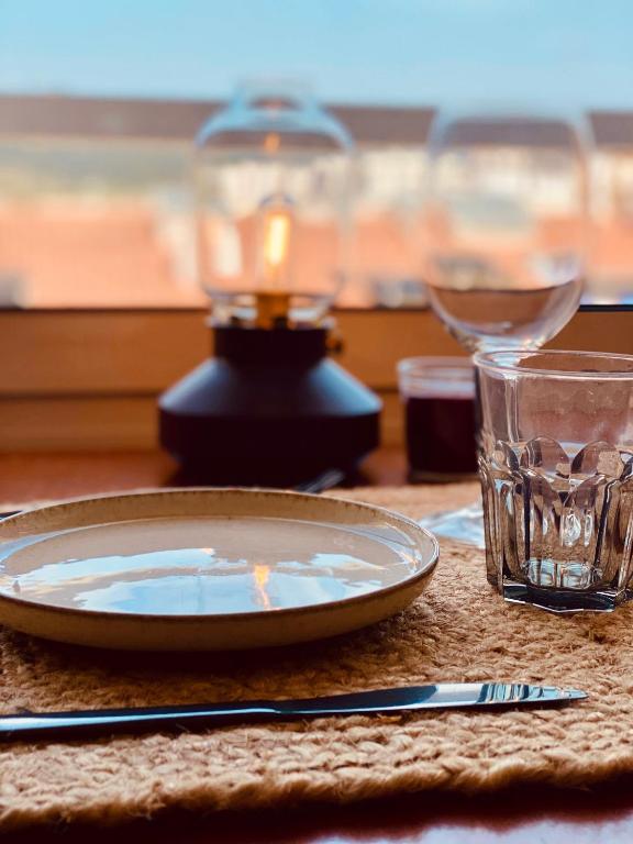 a table with a plate and a candle and a glass at LEB Apartments in Pineda de Mar