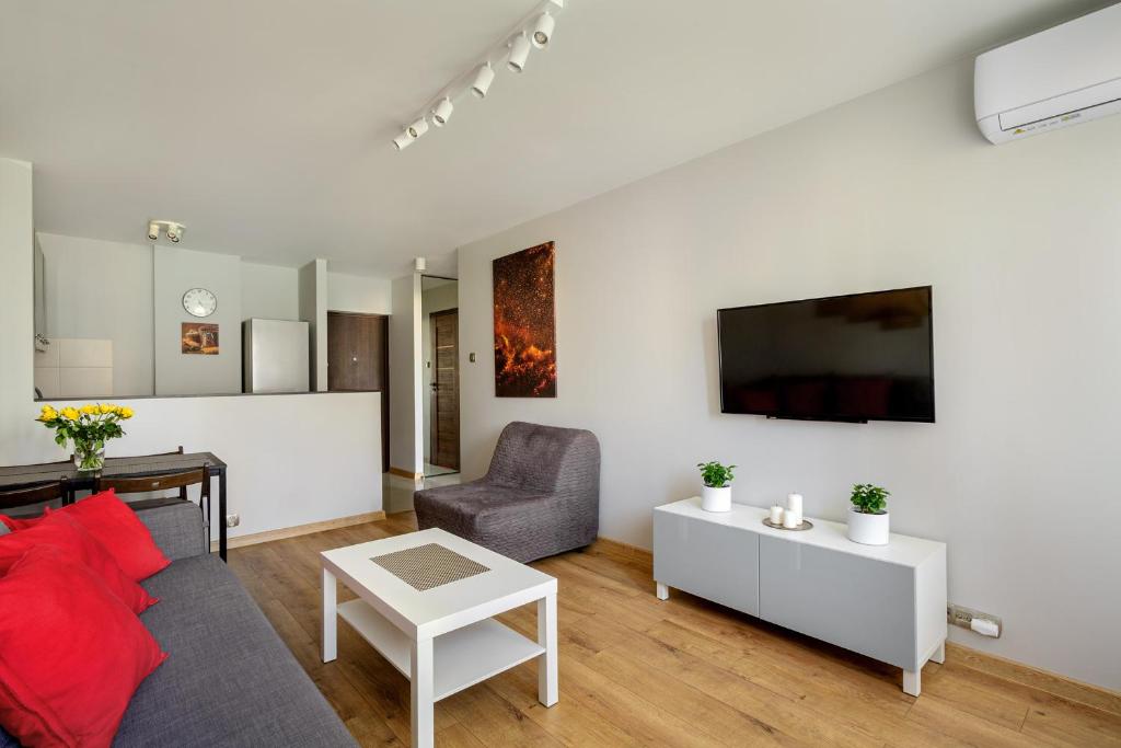 a living room with a couch and a table at Vorto Apartament 4 - Warszawa Centrum in Warsaw