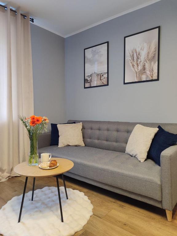 a living room with a couch and a table at Kosmonaudi Apartment in Narva