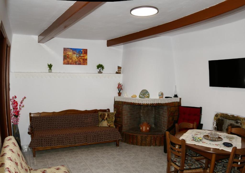 a living room with a couch and a table at Socros Home, Mesta Chios in Mestá