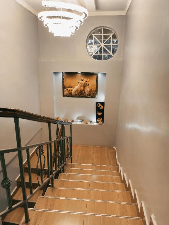 a staircase in a home with a chandelier at Kericho Finest Home in Kericho