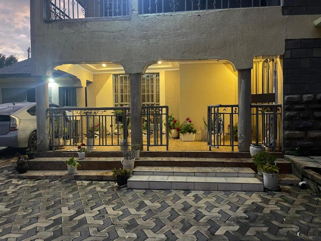 a house with a gate and stairs in front at Kericho Finest Home in Kericho
