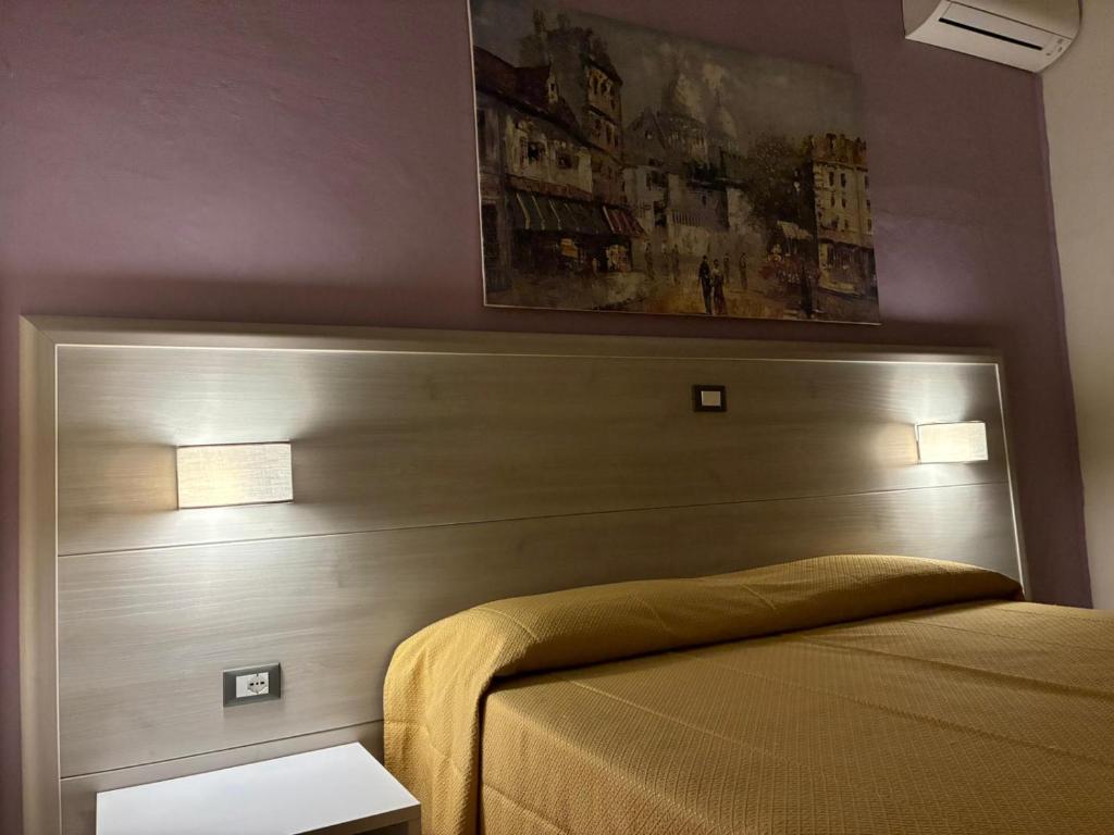 Postel nebo postele na pokoji v ubytování Hotel Annunziata