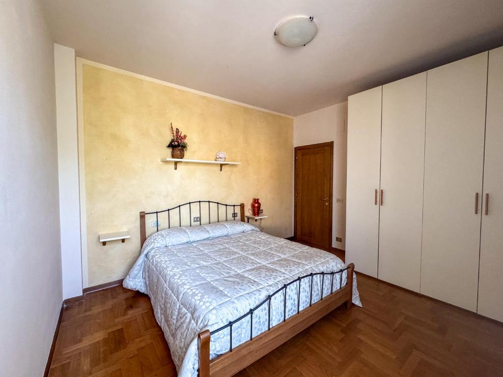 a bedroom with a bed and a shelf on the wall at Casa Toscana in Montespertoli