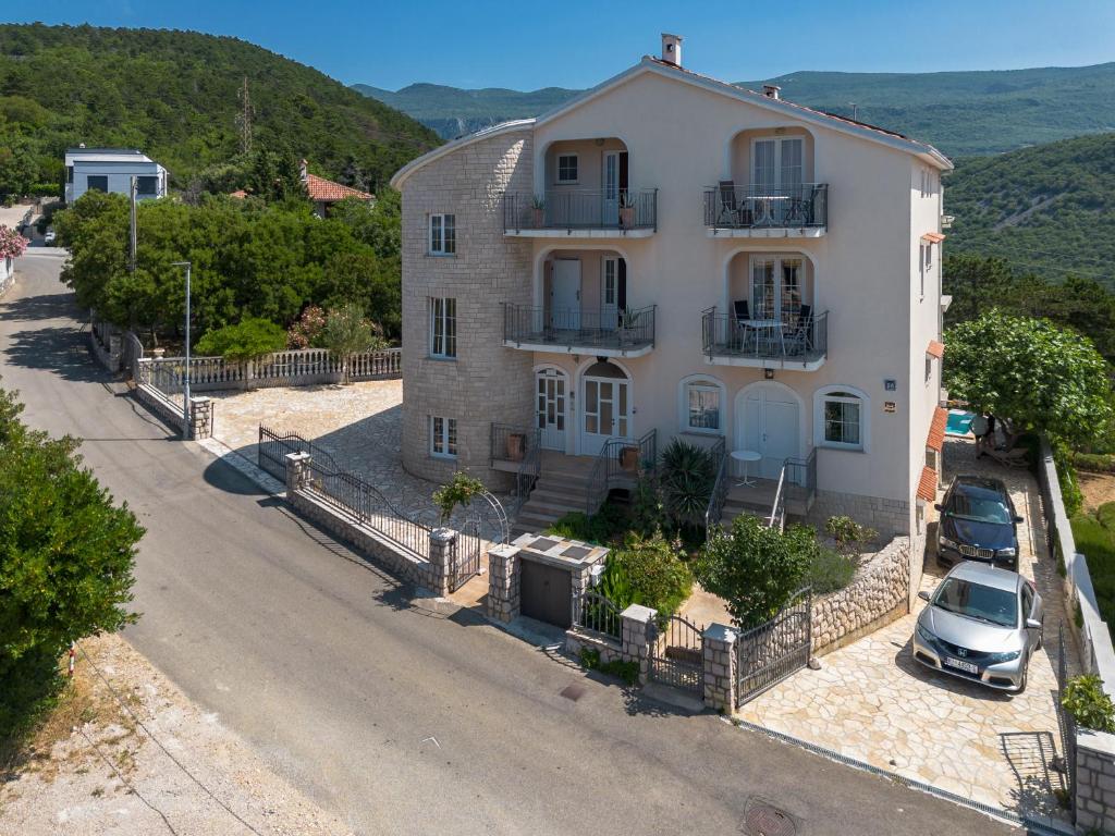 a house with a car parked in front of it at Kuca Orhidea in Crikvenica