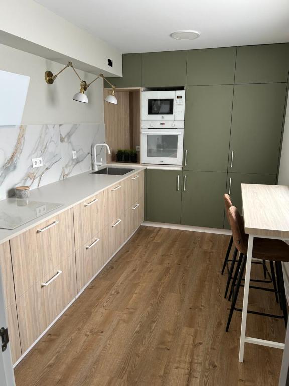 a kitchen with a sink and a stove top oven at Dania Home Noia in Noya