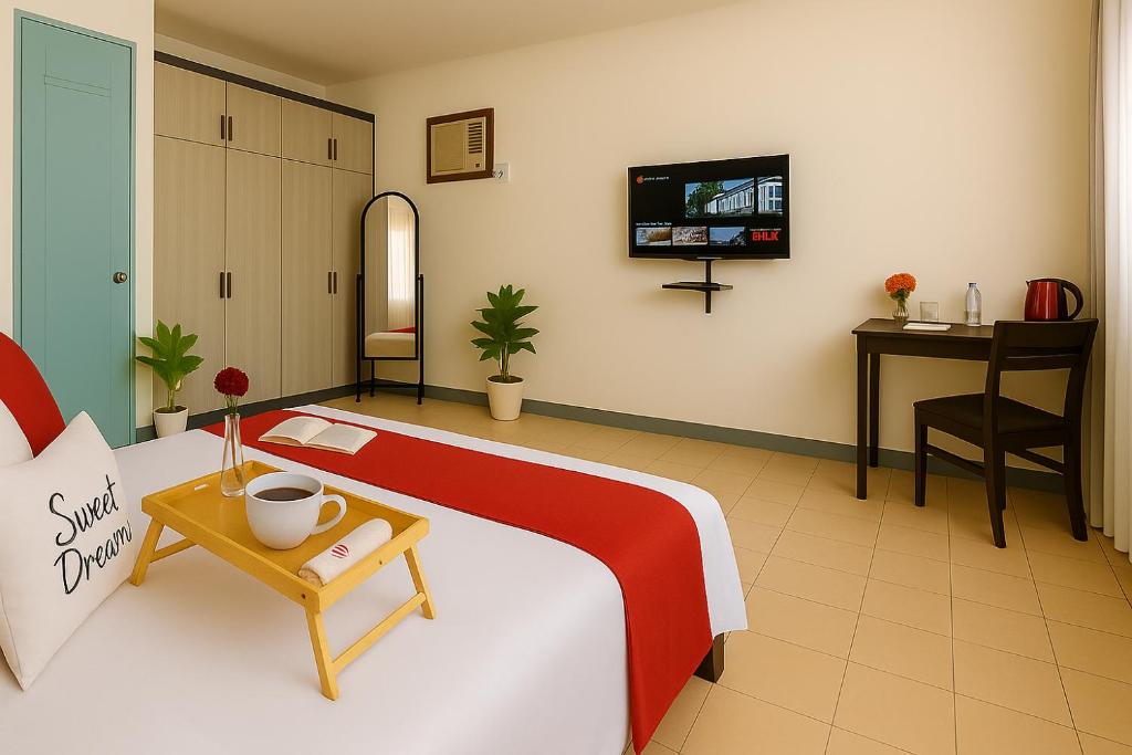 a room with a bed with a table and a tv at Queen room only near sm mall Fast Wifi in Malabañas