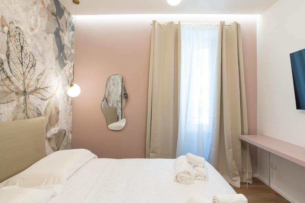 Postel nebo postele na pokoji v ubytování Maison Rasella Palace Suites